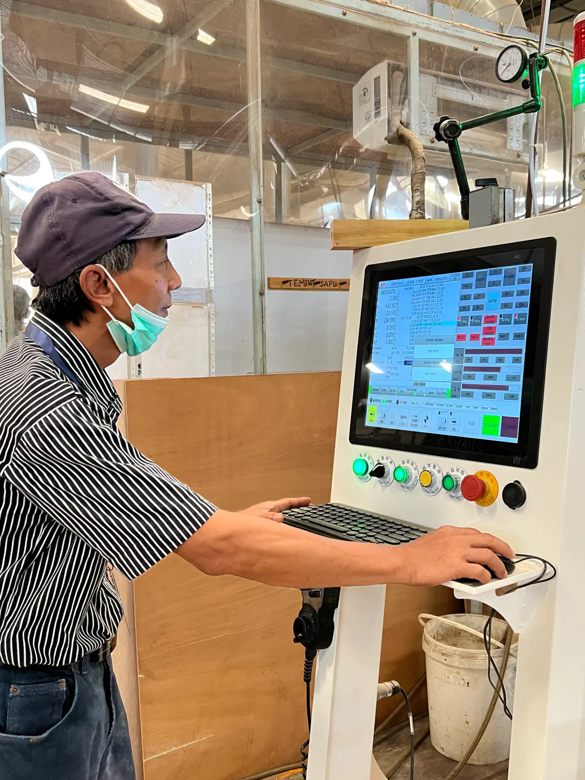 Danwood operator working with the CNC control system